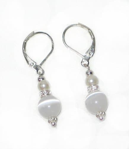 A Timeless Classic, Silver Plated Leverback Earrings feature a georgious pair of White Faux Pearls and White Cats Eyes, seperated by a Clear Rhinestones band for a finished touch.