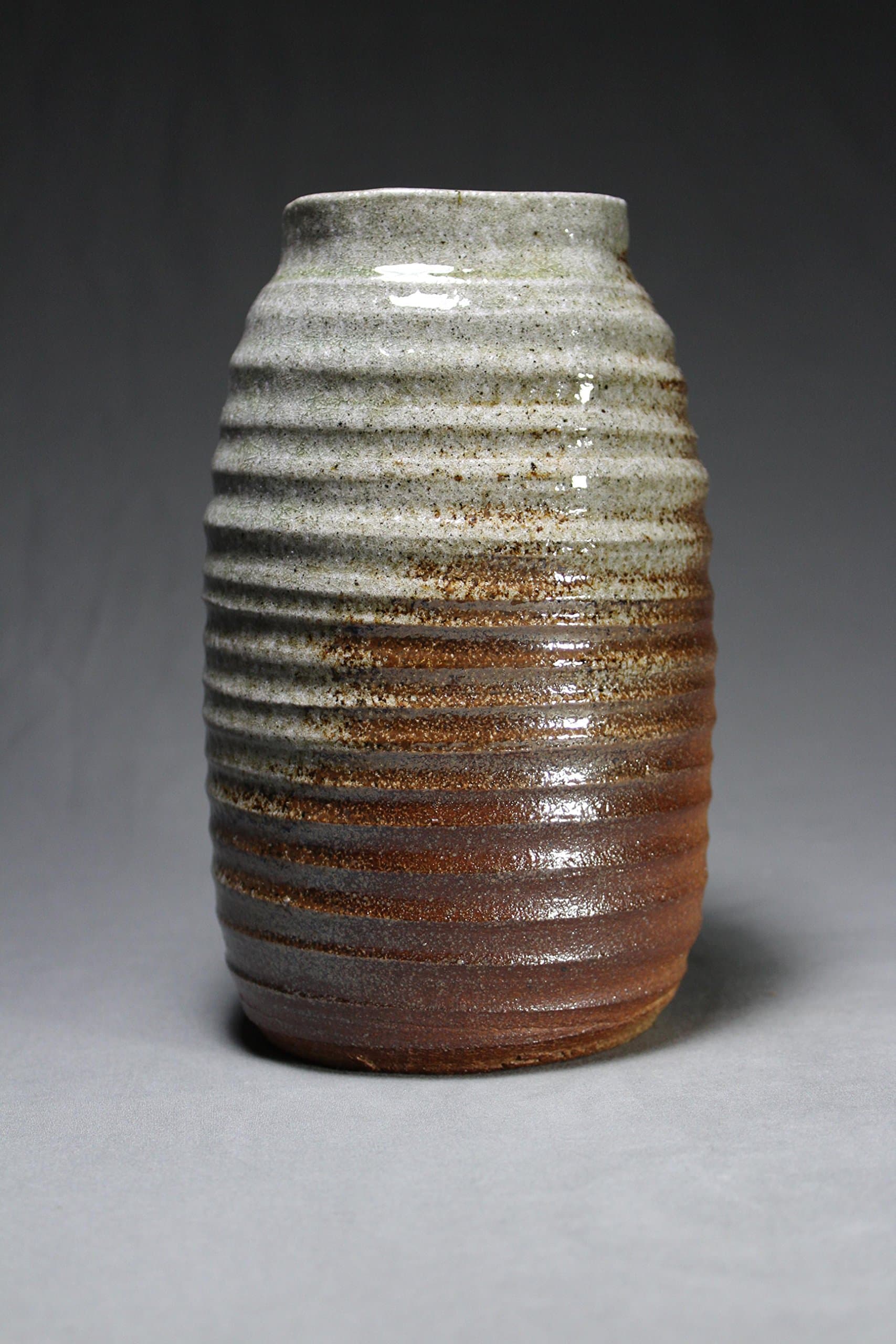 8.5 " tall Stoneware Soda Fired Vase with distinct throwing lines.